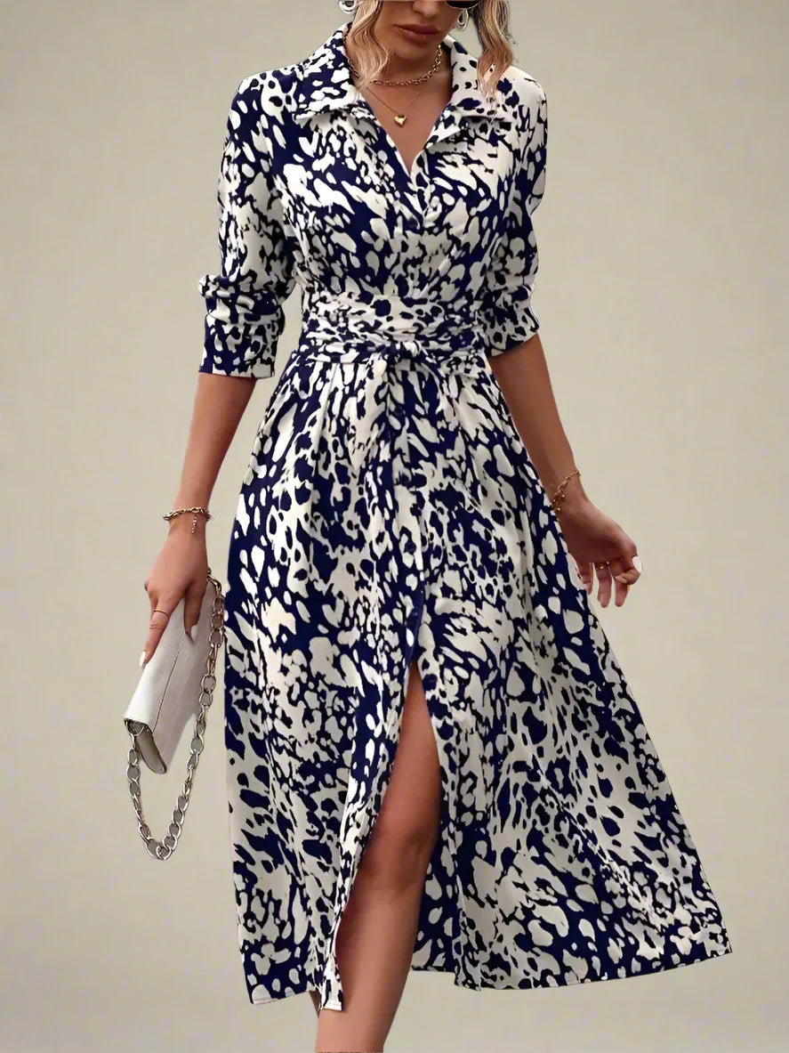 Woman wearing a blue and white patterned dress with a blurred background