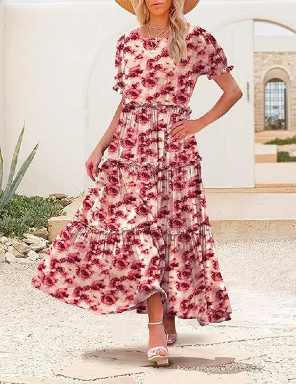 Woman wearing a floral dress standing outdoors with a building in the background