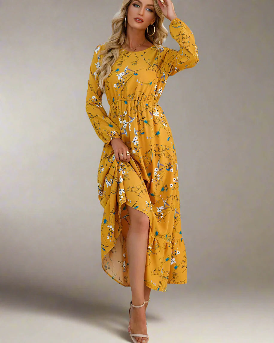 Woman wearing a yellow floral dress against a white wall.