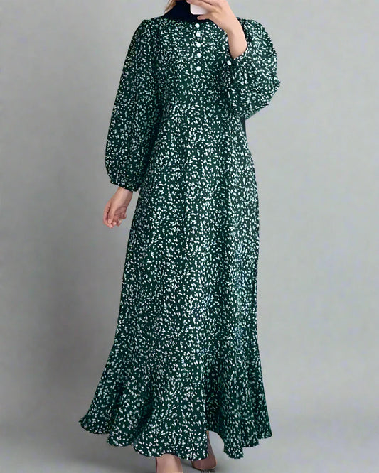 Green floral dress worn by a person in a minimalistic room.