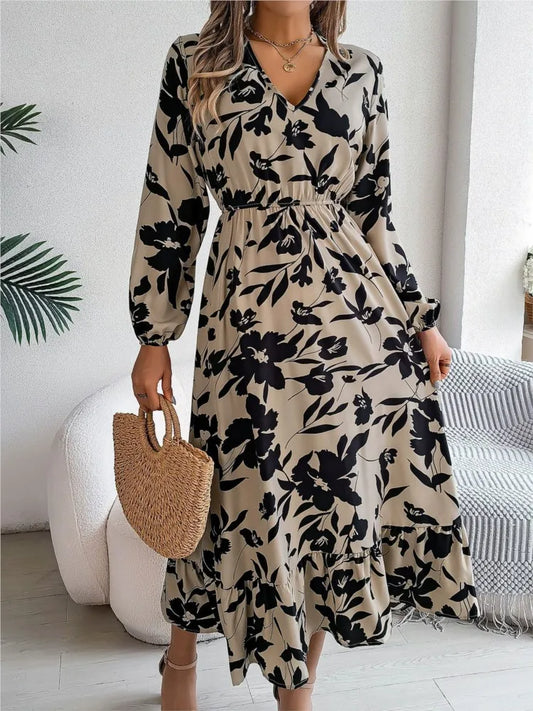 Woman wearing a floral dress holding a woven handbag indoors.