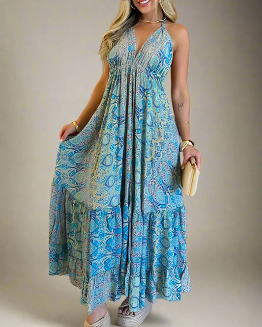 Woman wearing a blue patterned dress in a room with wooden walls.