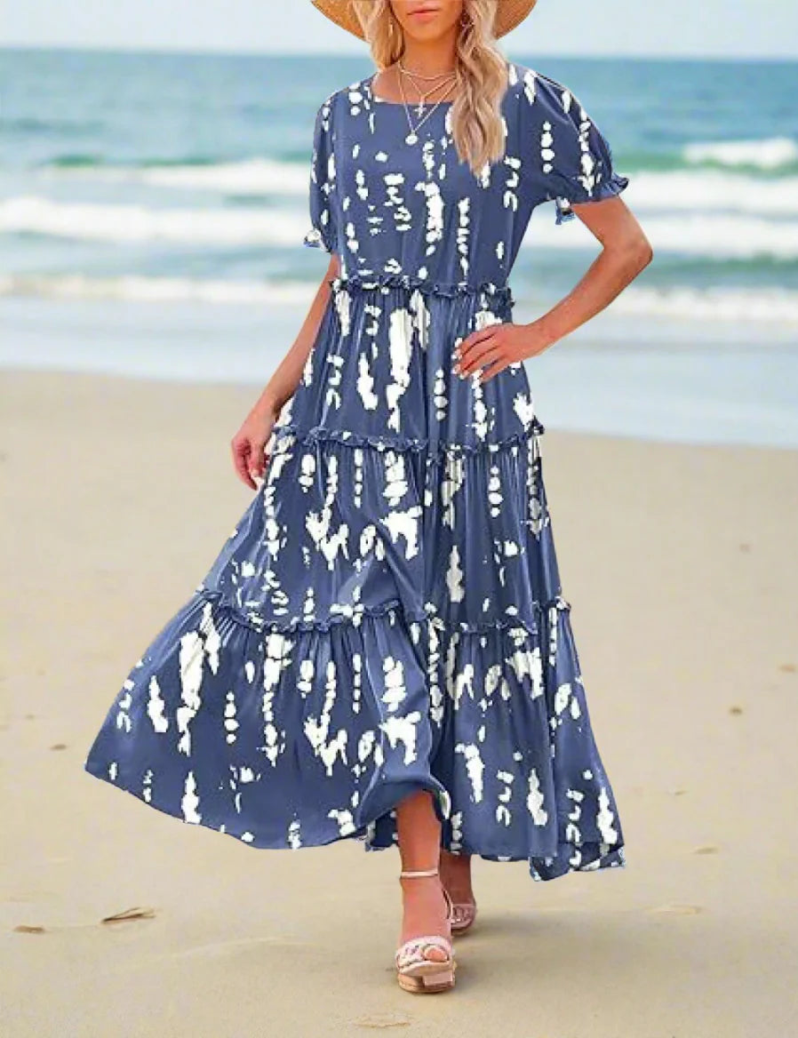 Woman wearing a blue and white patterned dress outdoors.