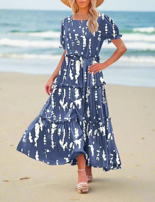 Woman wearing a blue and white patterned dress outdoors.