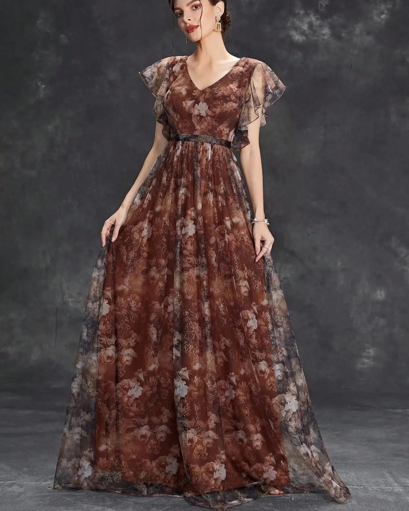 Woman wearing a floral dress against a dark background