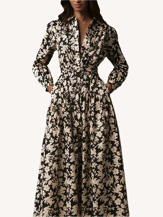 Woman wearing a black and white floral dress against a dark background